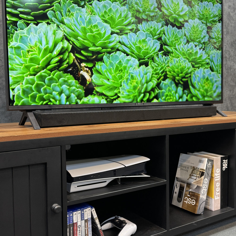 قرارگیری ساندبار زیر تلویزیون ال جی UA8500 با پایه‌های دو شاخه‌ و طراحی باریک